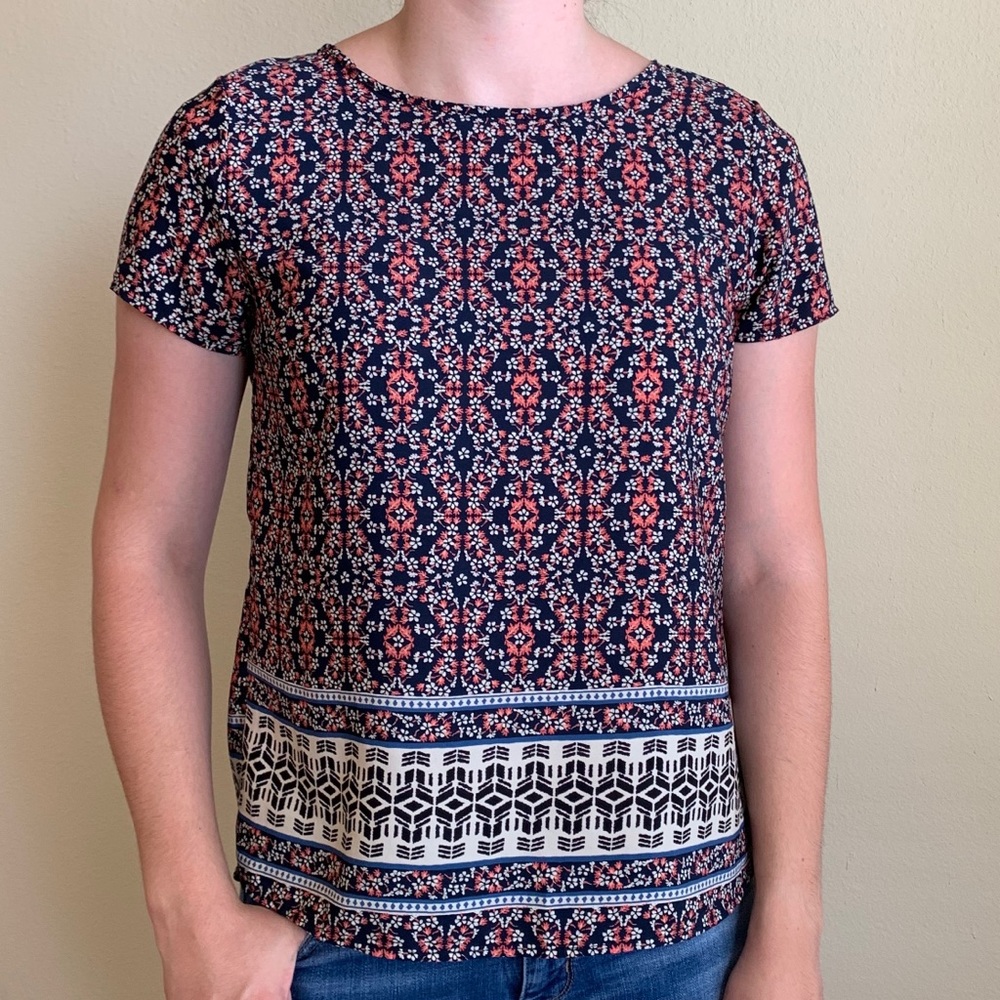 Mini coral floral on dark navy blouse.
